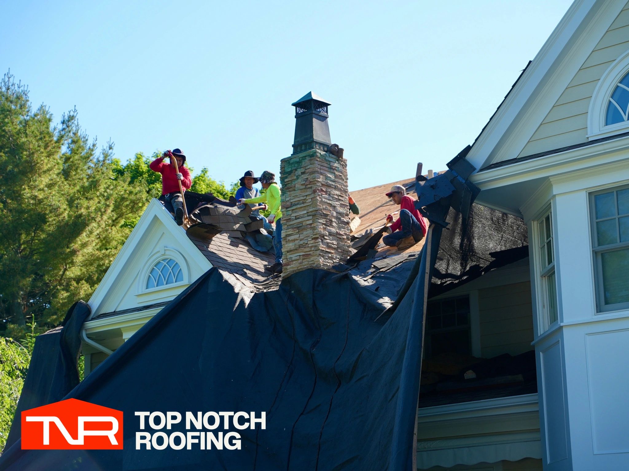 Professional roofer installing shingles on Seattle home